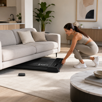 Compact walking pad folded and stored near a sofa in a UK living room