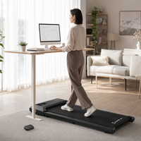 Person walking on a foldable walking pad at a standing desk in a UK home